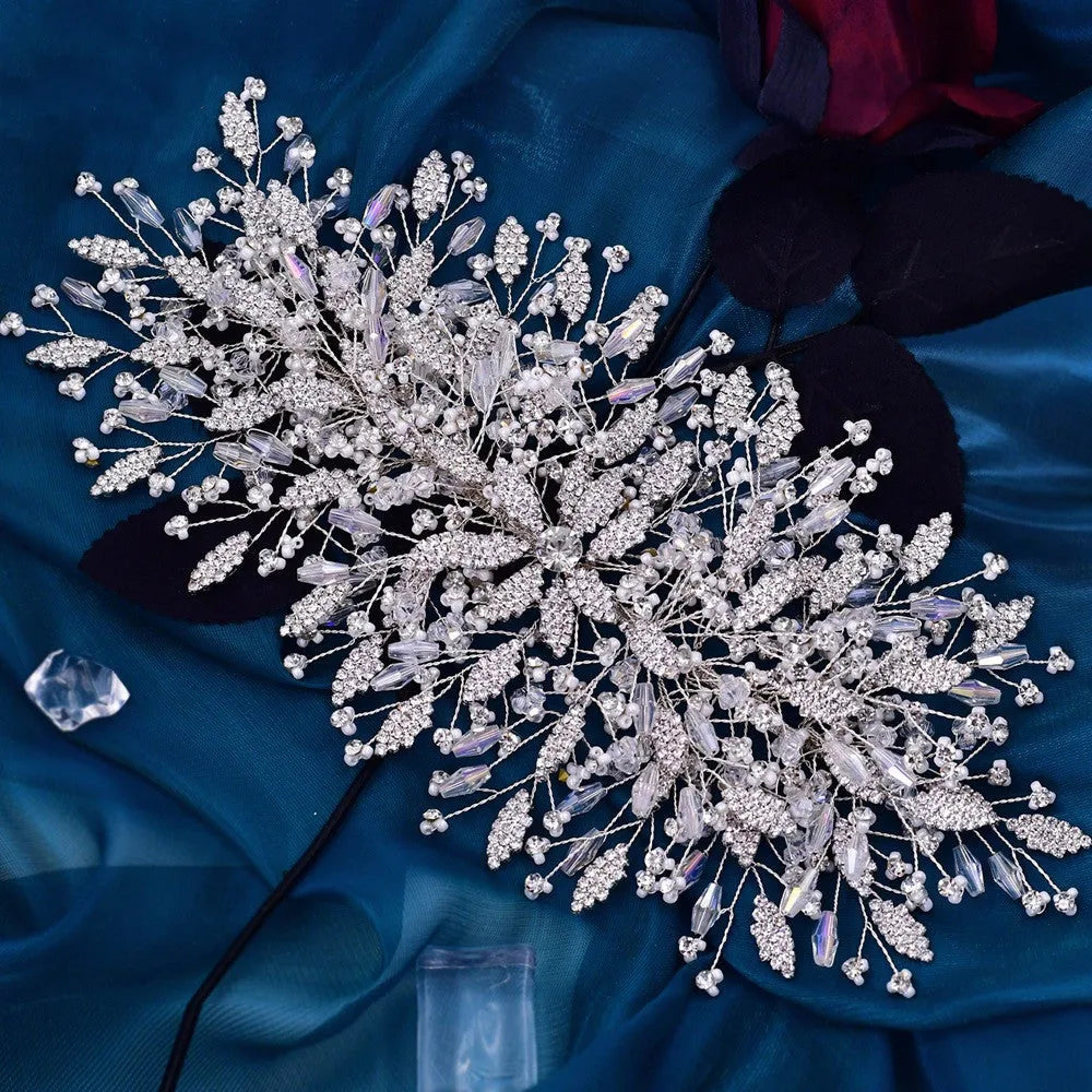 Gold rhinestone wave bridal headpiece and matching earrings set on display