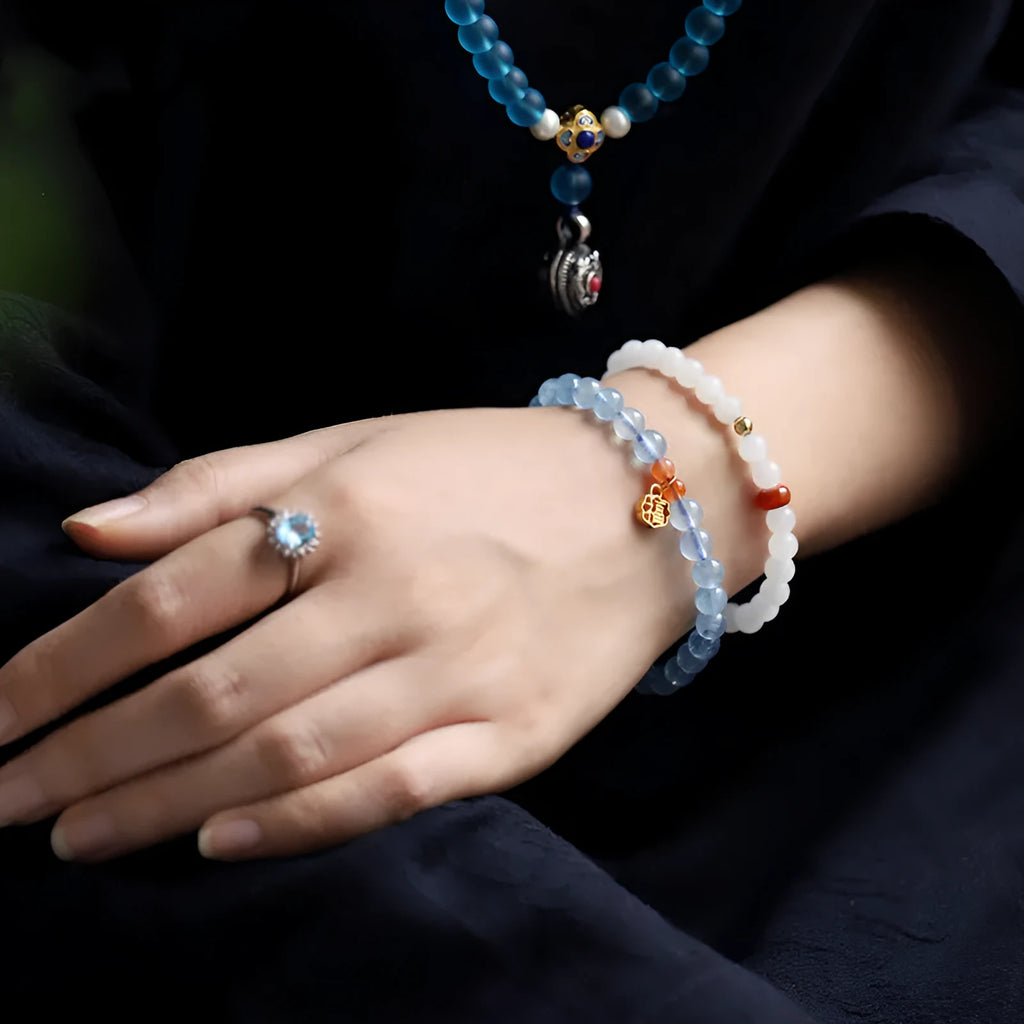 Women's ice translucent bracelet with 8mm crystal beads and a blessing card charm on a white background.