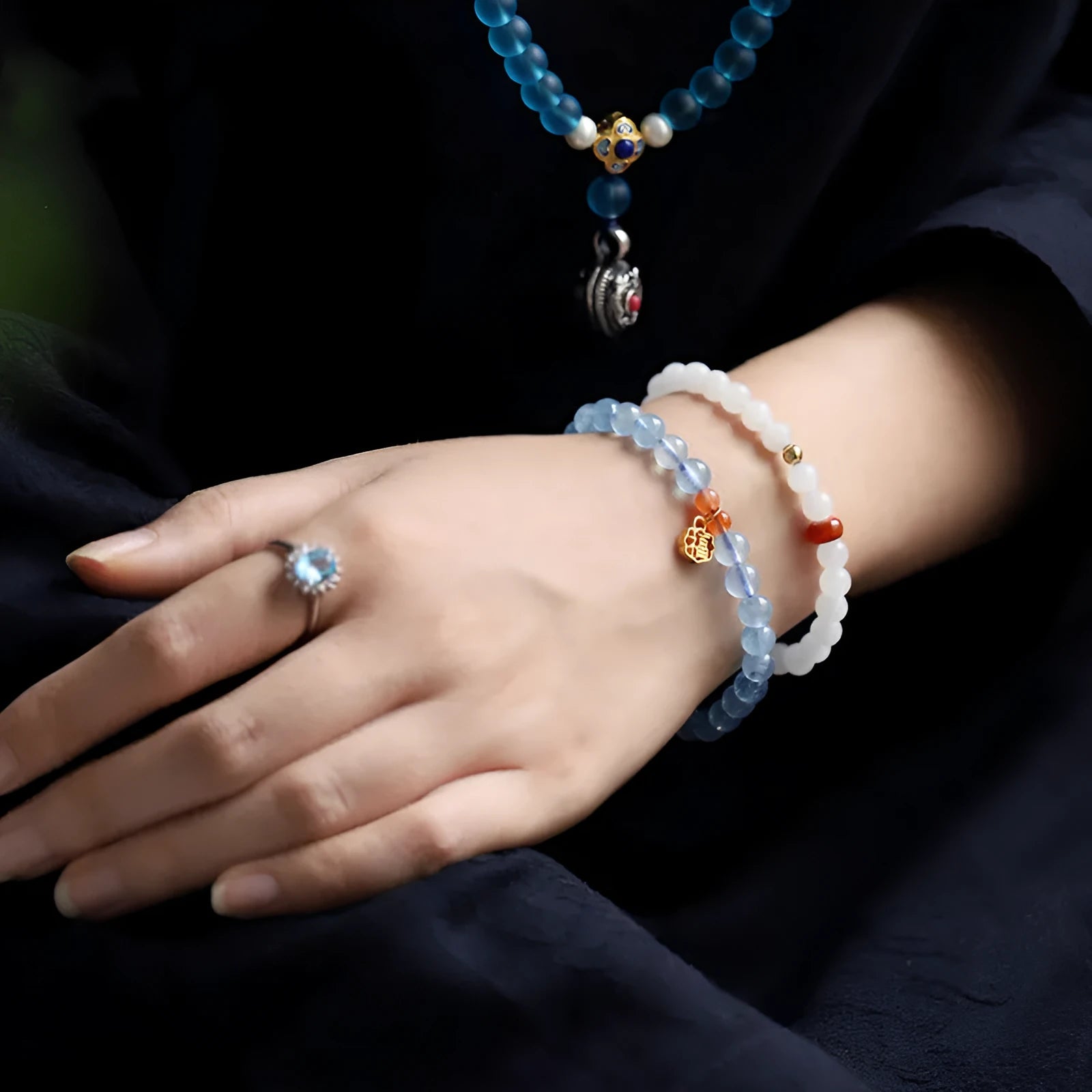 Women's ice translucent bracelet with 8mm crystal beads and a blessing card charm on a white background.
