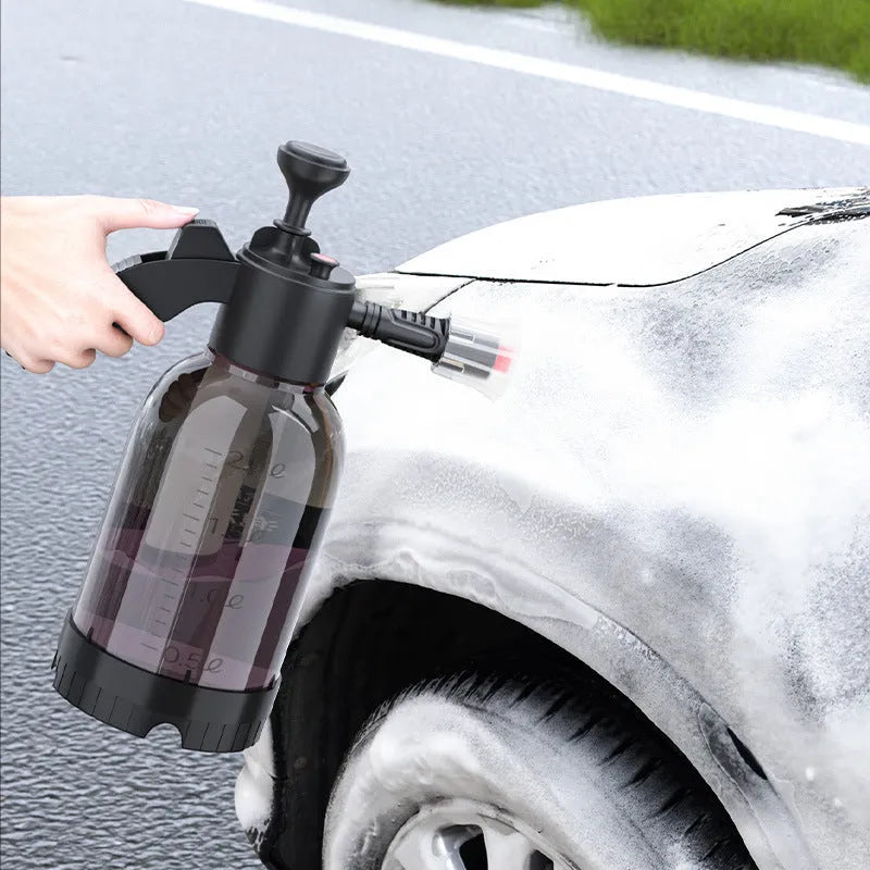 Black hand-held 2 litre foam sprayer with lock switch and nozzle attachments