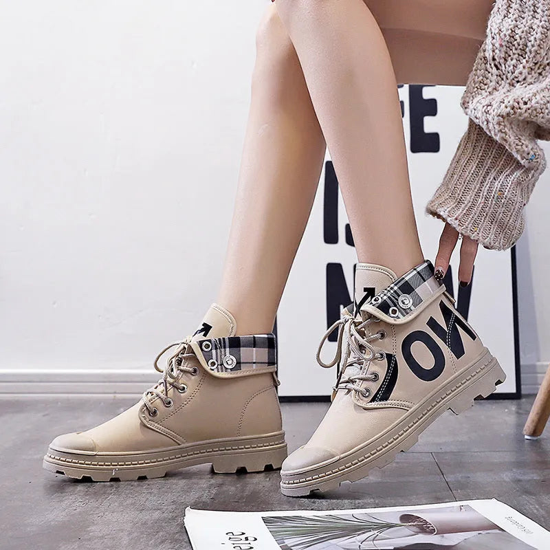 Women's high-top canvas short boots with cross straps and buckles in black, side view