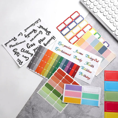 Assortment of paper adhesive stickers, labels, A6 rulers, and sticky notes in various colours and grid layouts.