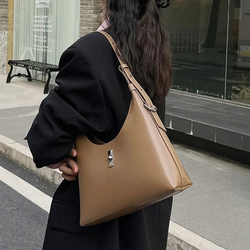 Soft genuine leather dumpling-shaped crossbody bag in apricot colour with visible stitching.