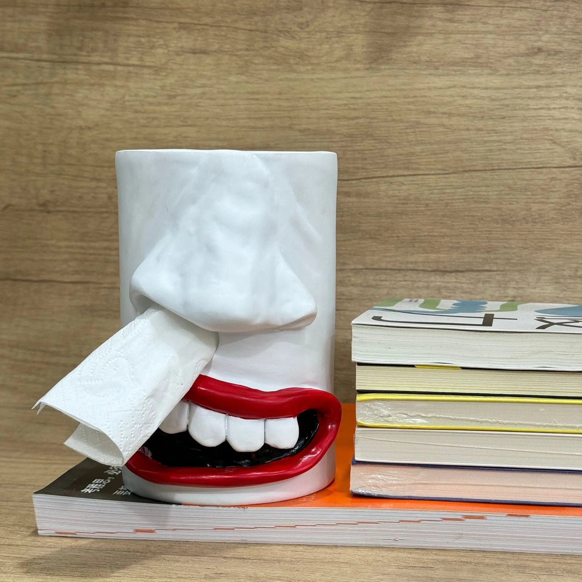 A fun-coloured resin decorative holder for a tissue box, shown on a desktop.