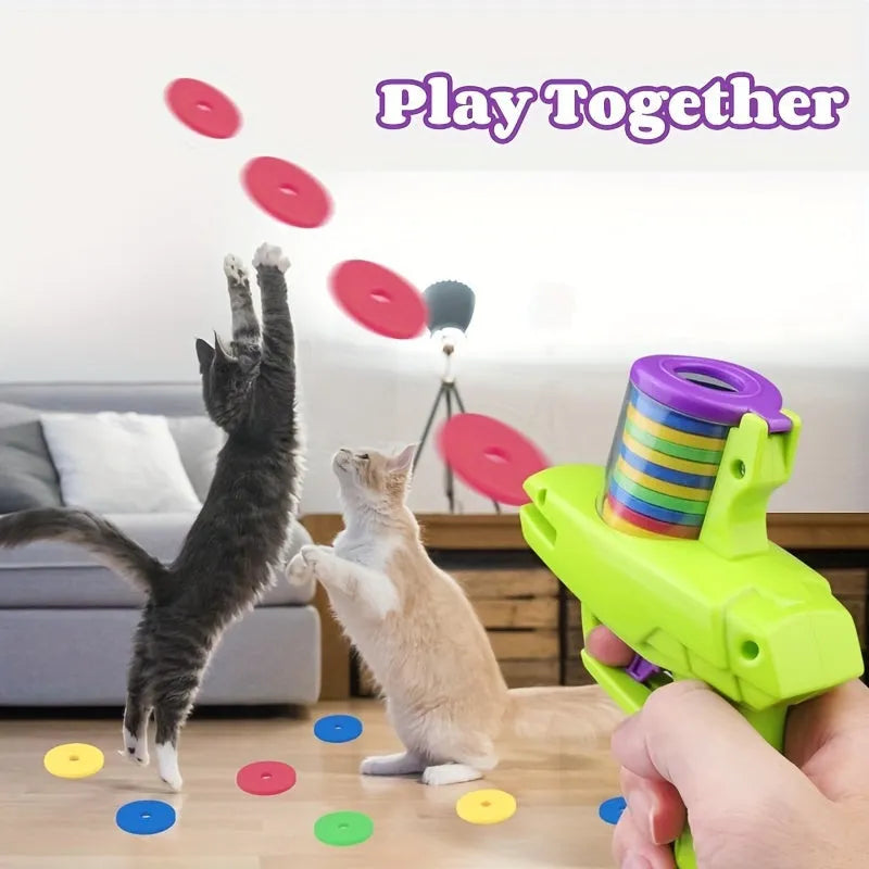 Green and purple manual cat toy launchers with foam discs for interactive indoor pet play