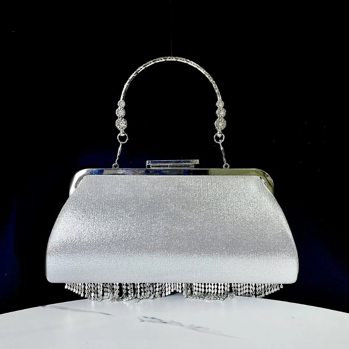 Tassel banquet bag in silver, gold or black polyester with shell shape and chain detail