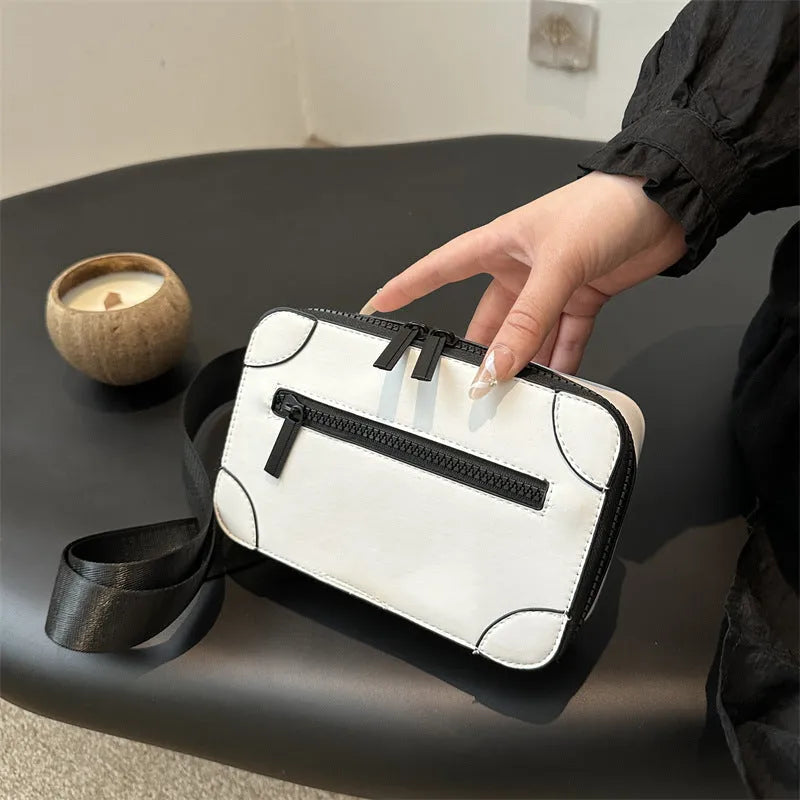 A dark grey women's square crossbody bag made of PU leather, shown with a single shoulder strap and visible sewing line detail.