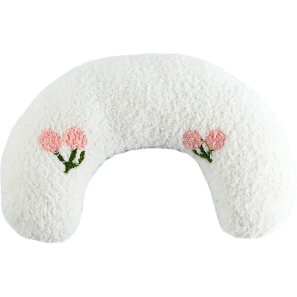 White U-shaped plush pet pillow for a cat, showing its donut shape and quilted texture.