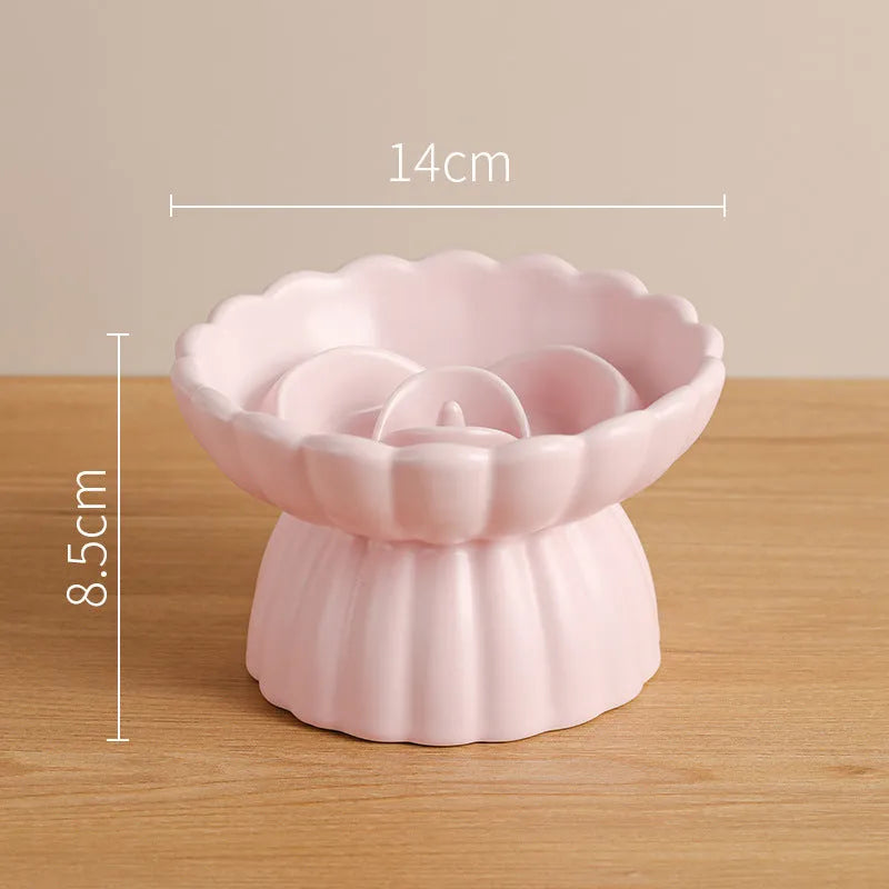 Ceramic slow feed dish with flower pool design and higher edges for cats and small dogs, shown in pink.