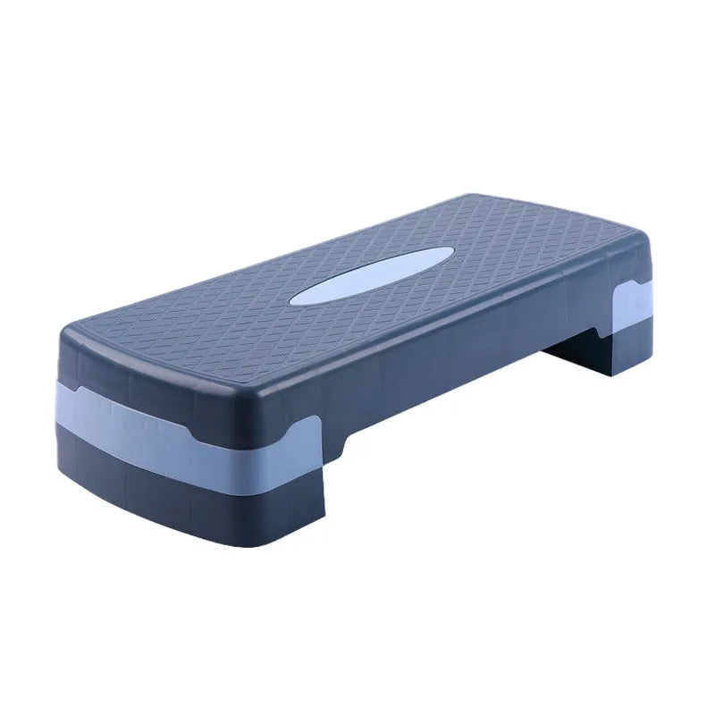 Grey Fit Step aerobic platform on a wooden floor, showing its non-slip textured surface.