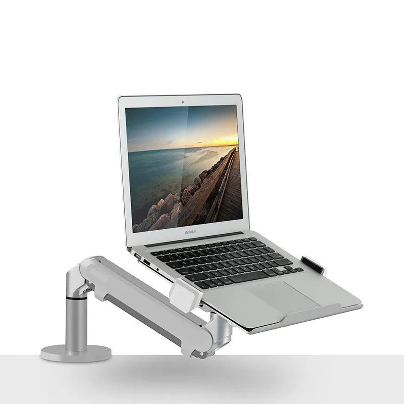 Black aluminium laptop stand with adjustable arm bracket raised above a desk.