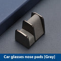 Zinc alloy and leather car dashboard clip for holding sunglasses, shown in green colour.