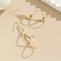 Geometric spiral design earrings with electroplated gold finish and ellipse shape