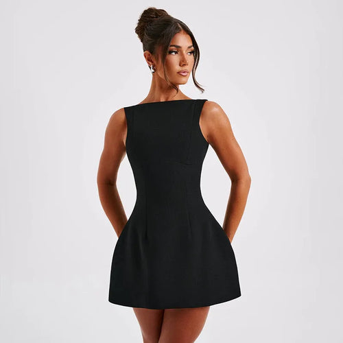 Black backless sling dress with slim fit and short skirt on a model.