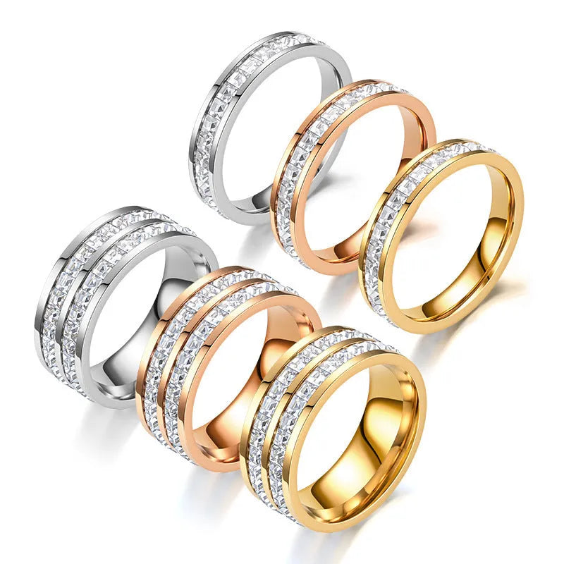 Stainless steel geometric star ring with zircon inlay in gold finish on white background