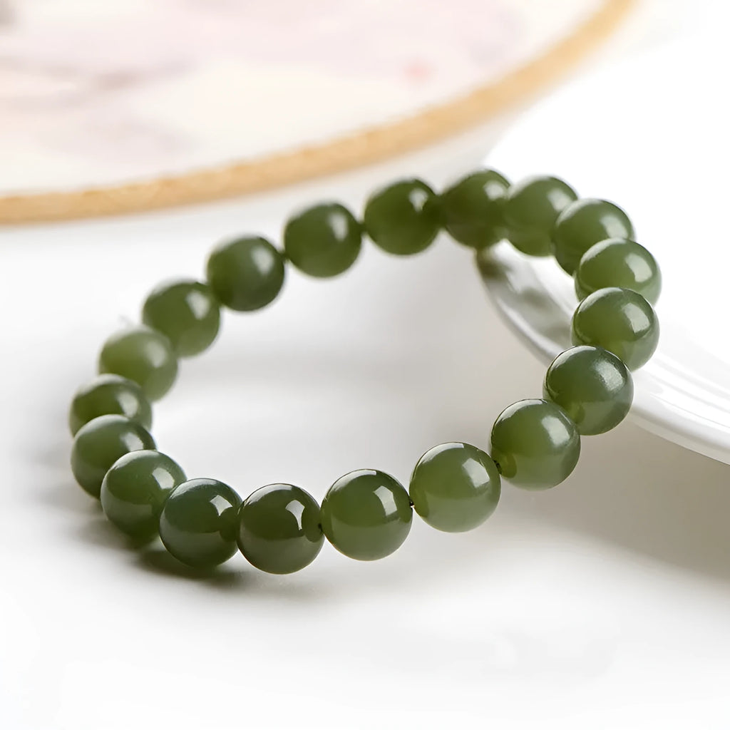 Polished Hetian jade bead bracelet in ice-like clear tones on a white background.