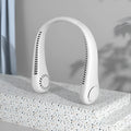 White bladeless neck fan hanging around neck with USB charging cable