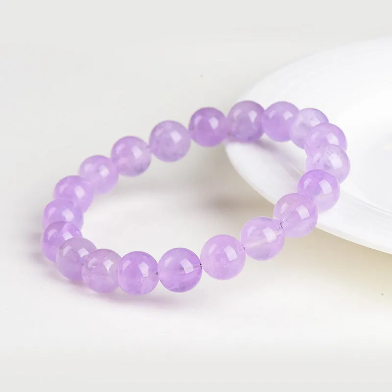 Lavender amethyst round bead bracelet with water ripple pattern on a table.