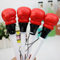 Four black boxing press ejection pens with a bullet-shaped 0.7mm tip on a desk.