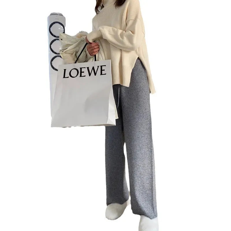 Women's high-waisted wide-leg knitted trousers in cream white, casual autumn winter style.