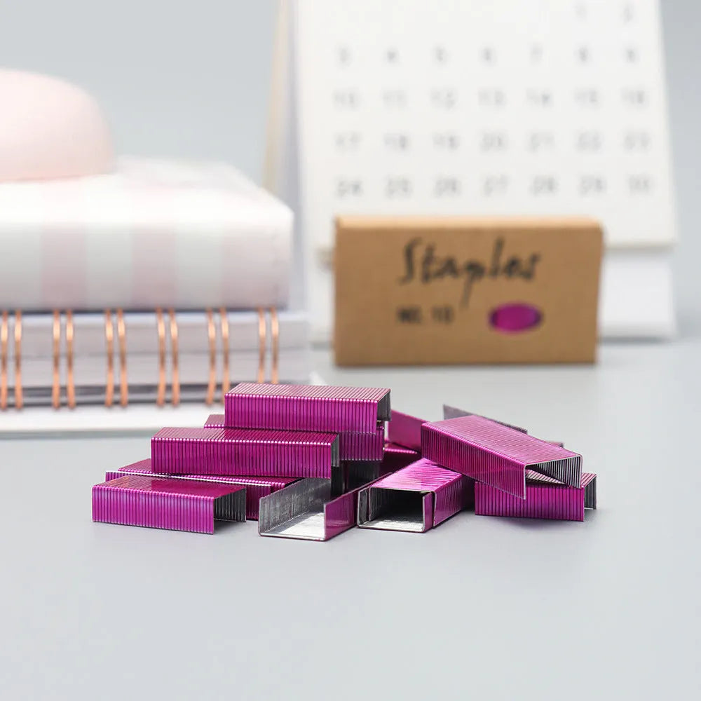 Box of 1000 metal office staples available in black, purple, rose gold, and rose red colours.