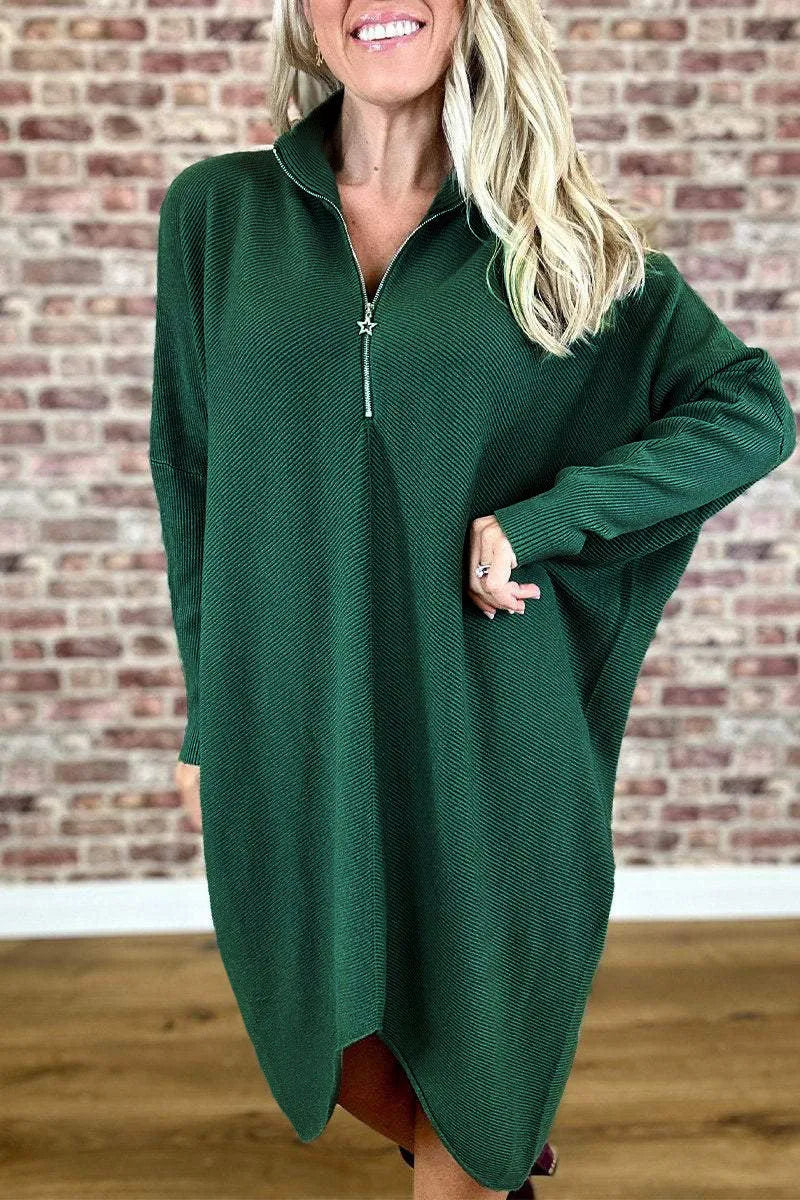 A women's solid colour loose knitted dress with raglan sleeves and a front zipper.