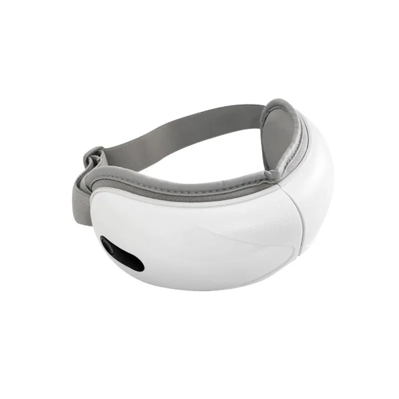 White rechargeable airbag eye massager with heat compress function on a grey background.