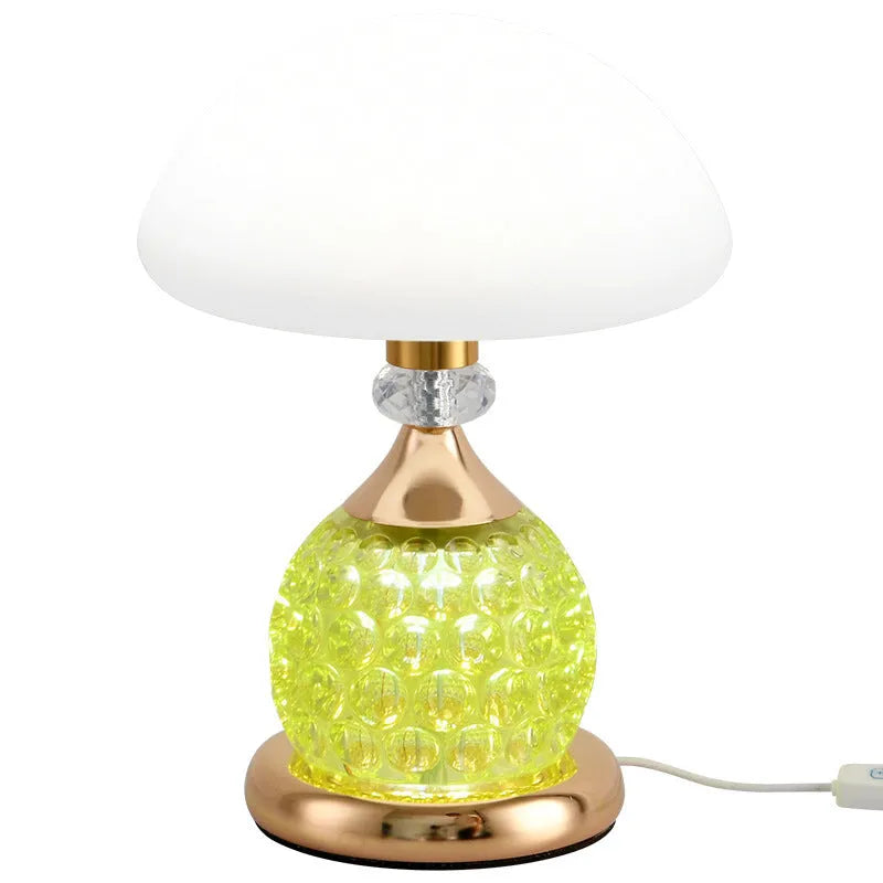 Light luxury mushroom table lamp in transparent colour option on a bedroom desk with USB cable connected.