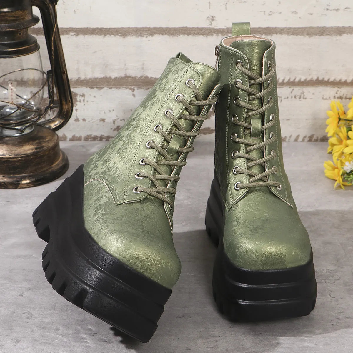 Women's black platform Martin boots with side zip and chunky rubber sole.