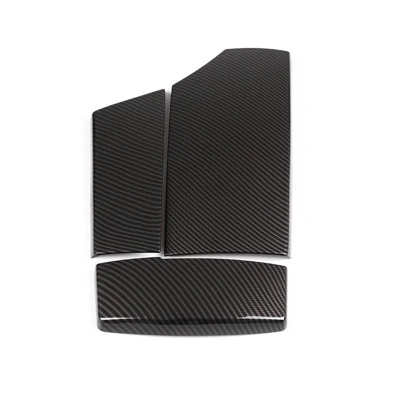 Set of three black ABS car armrest box protective covers with a diagonal carbon fibre weave pattern and shiny finish.