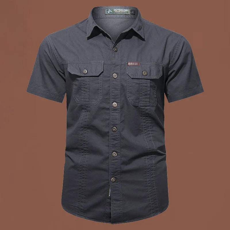 Men's army green cotton work shirt with short sleeves and non-iron finish on a hanger.