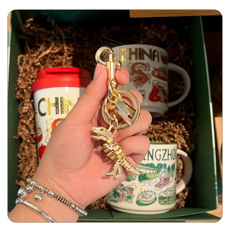 Golden Bone Dragon zinc alloy dinosaur keychain on a white background