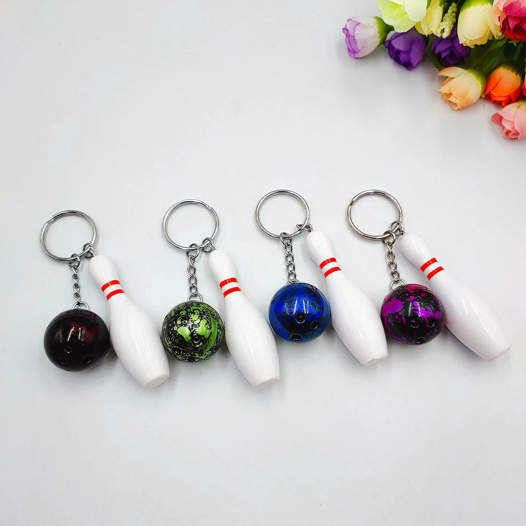 Mini simulation bowling ball keychain pendant in dark red, blue, purple, and green colour options.