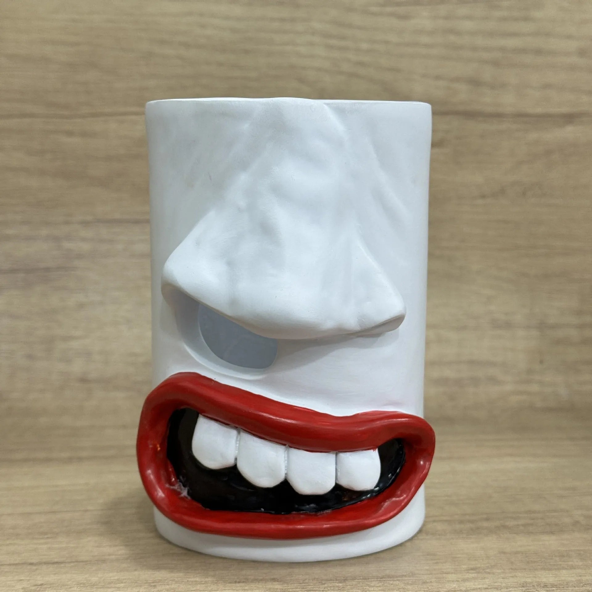 A fun-coloured resin decorative holder for a tissue box, shown on a desktop.
