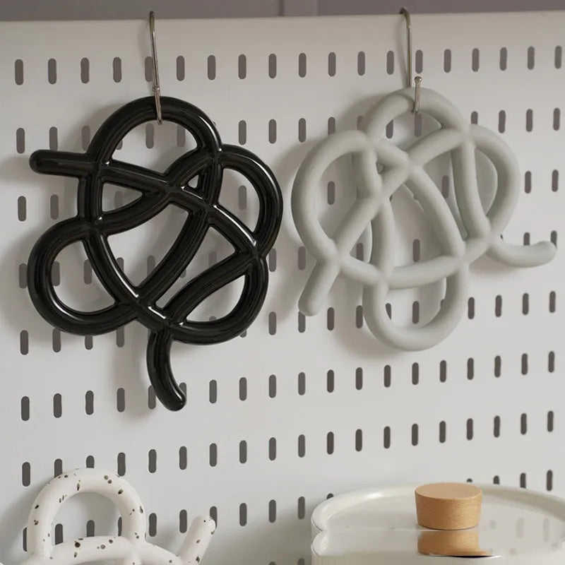 Ceramic heat proof mat with irregular modern shape in bright black, splash ink, or coconut milk grey colour