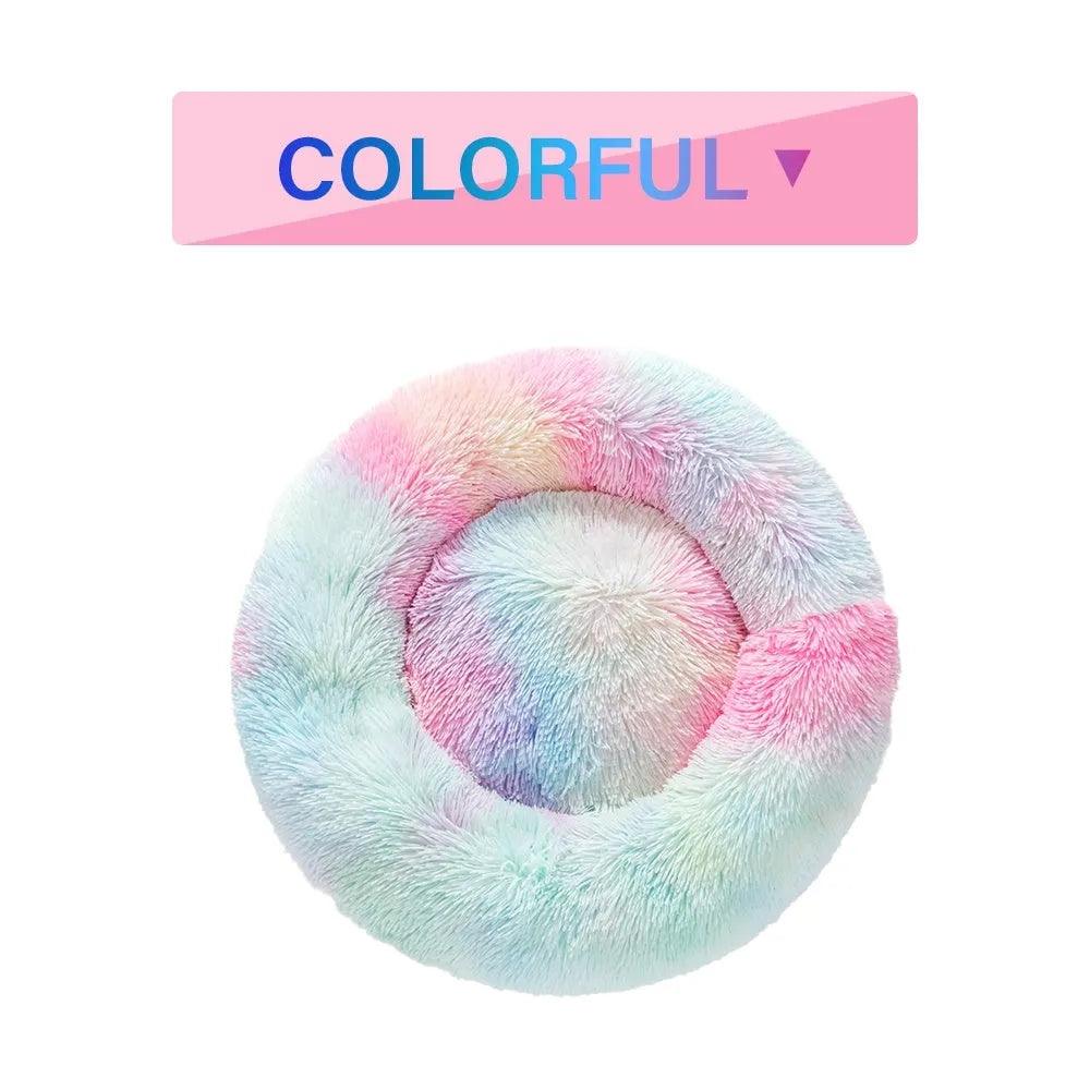 Fluffy donut-shaped dog bed in light grey plush material, showing raised rim and central cushion.