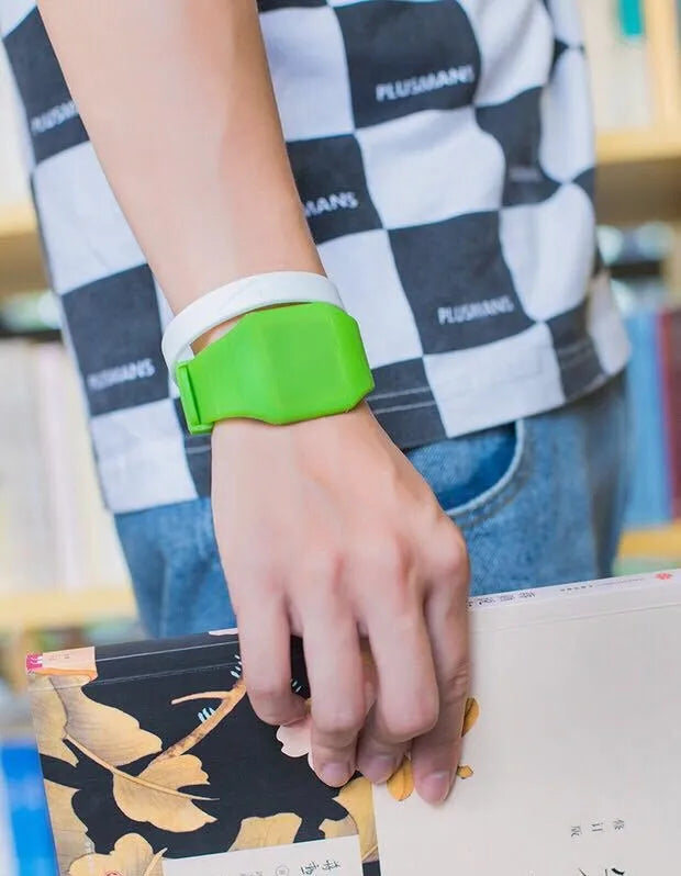 Square electronic touch screen watch with plastic case and PU strap on a wrist.