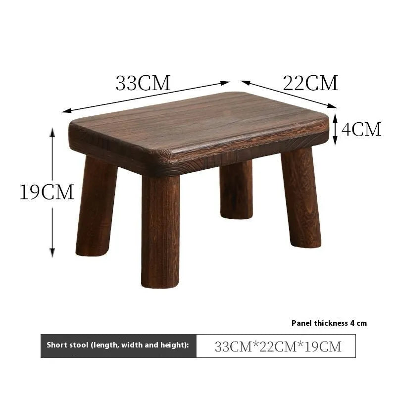 Solid wood distressed finish changing stool with bracket structure legs.