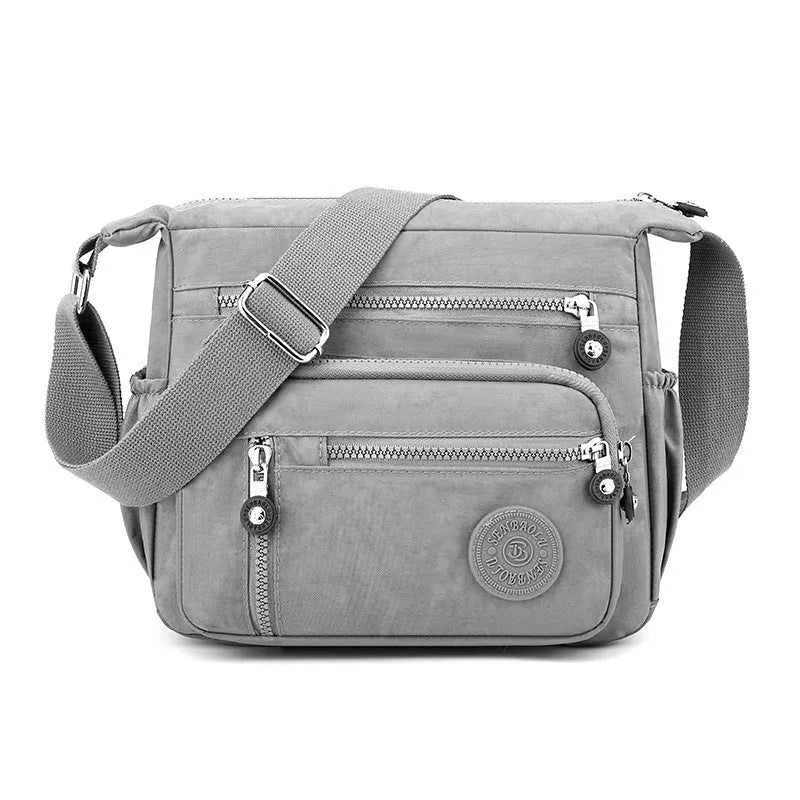 Grey square vertical nylon messenger bag with a single shoulder strap shown open.
