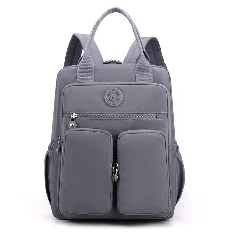 Waterproof nylon travel backpack in lotus root purple colour, showing multiple internal compartments and an external 3D pocket.