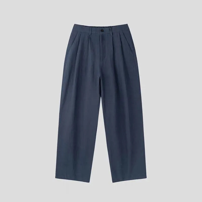 Men's apricot loose-fit cotton linen trousers with a pencil pants leg opening and micro-elastic waistband.