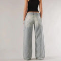 Blue loose fit wide leg mop trousers with low waist and straight leg cut on a person.