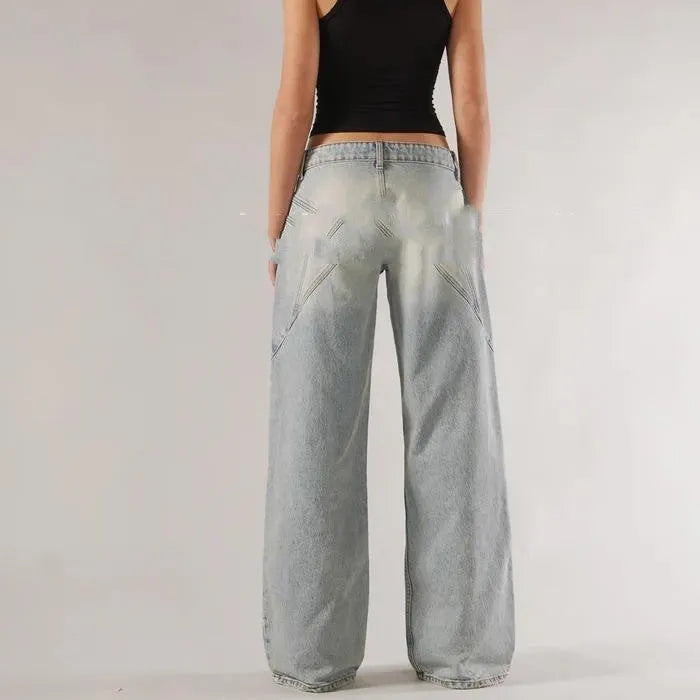 Blue loose fit wide leg mop trousers with low waist and straight leg cut on a person.