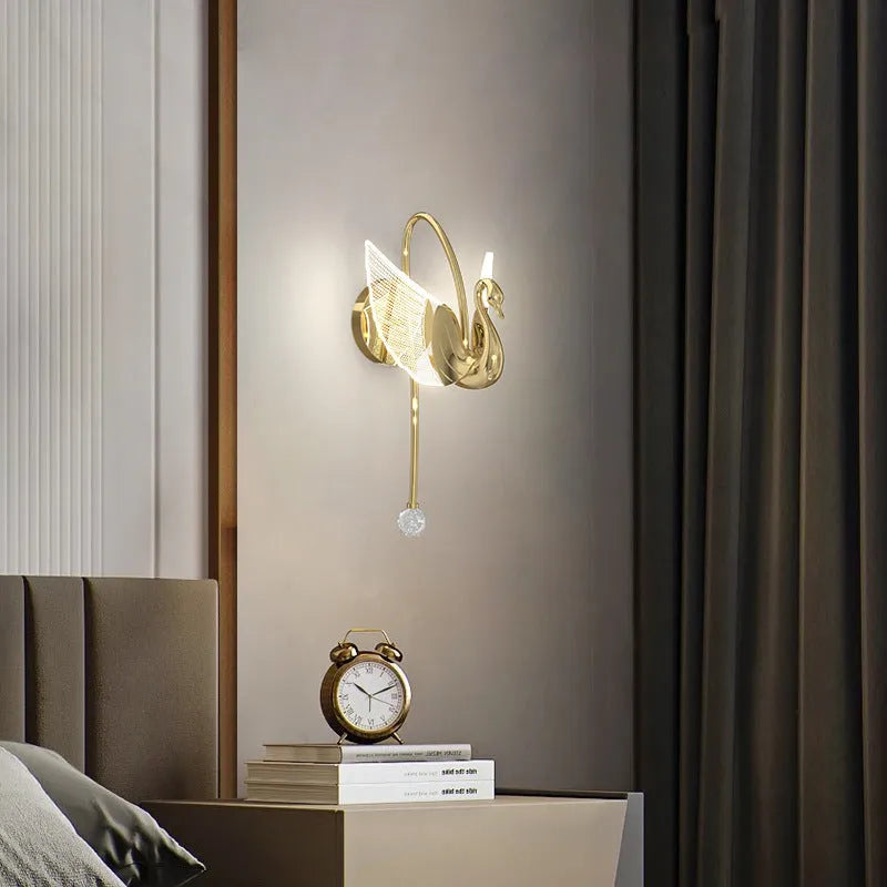 Modern minimalist gold swan-shaped LED wall lamp for bedside lighting.