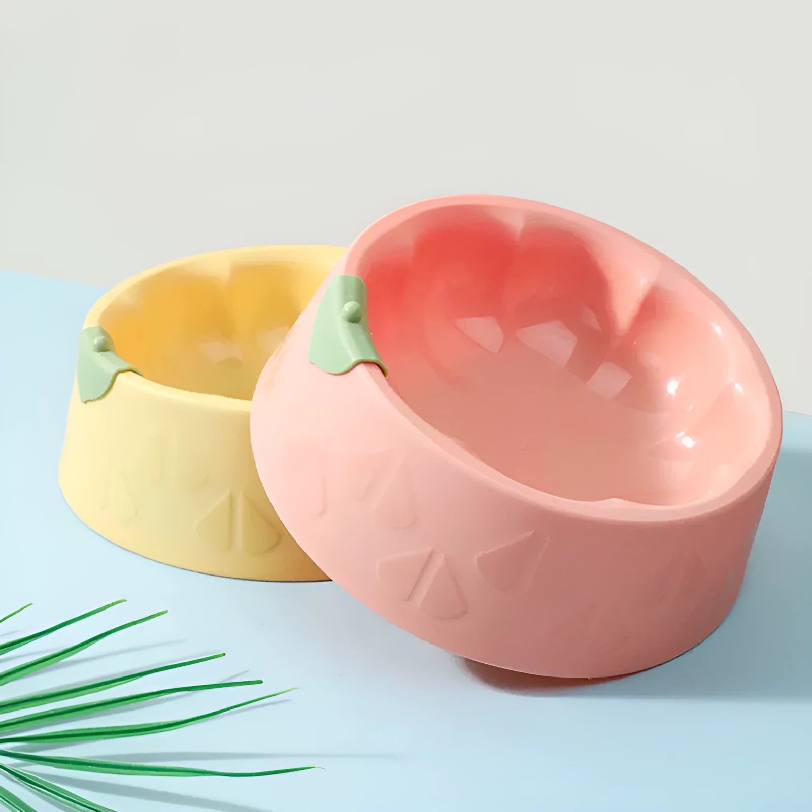 Green plastic double pet bowl for food and water with a flower-shaped, anti-tipping design.