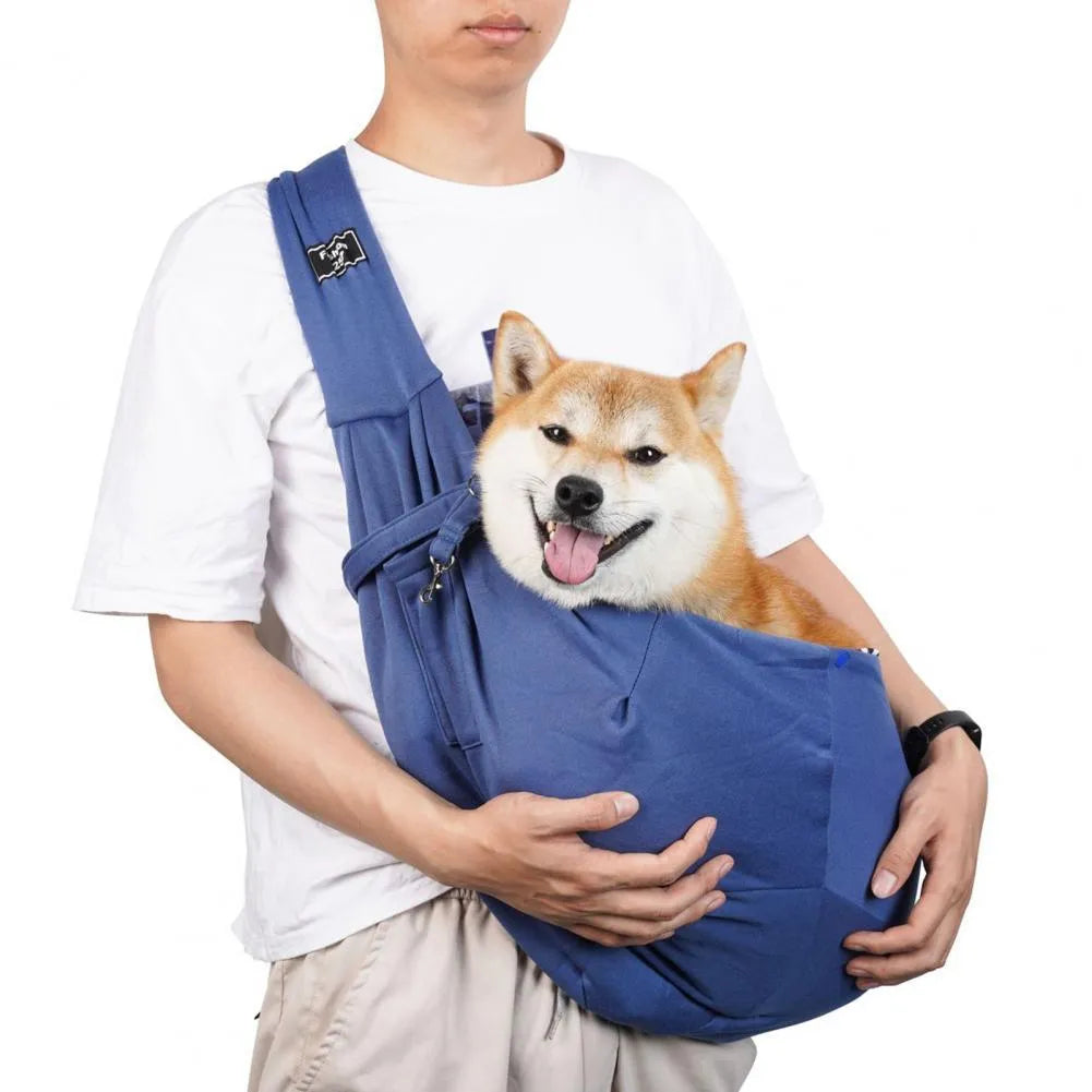Large grey folding cat messenger backpack with mesh windows, shown on a person's back.