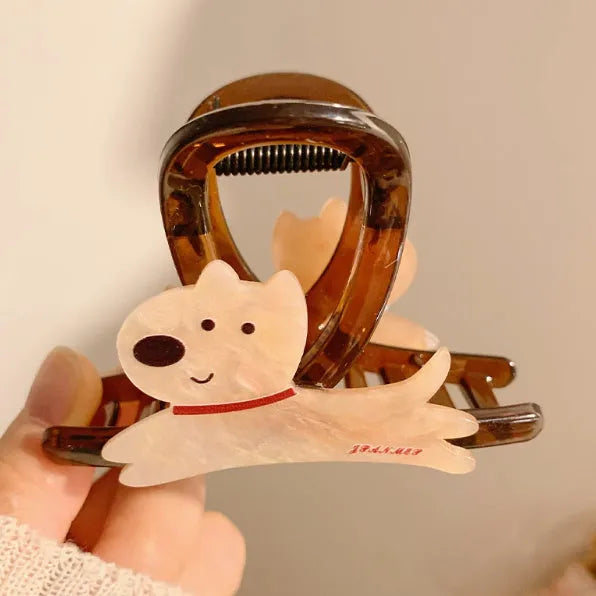 Cartoon puppy design hair barrette clip in beige and brown colours on a white background.