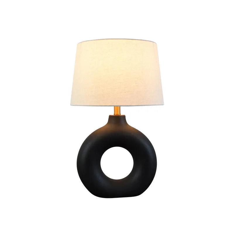 Feng pottery pot table lamp in Japanese style on a wooden desk.