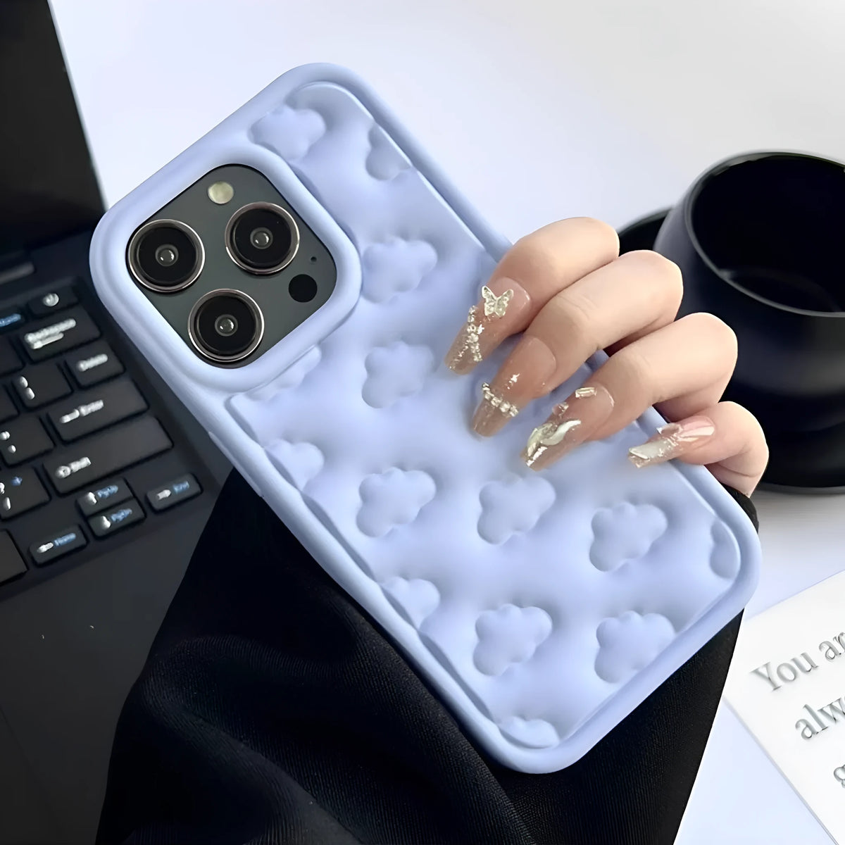 Hand oil three-dimensional cloud TPU phone case for iPhone with embossed floral pattern, black colour, displaying full back and edge coverage.