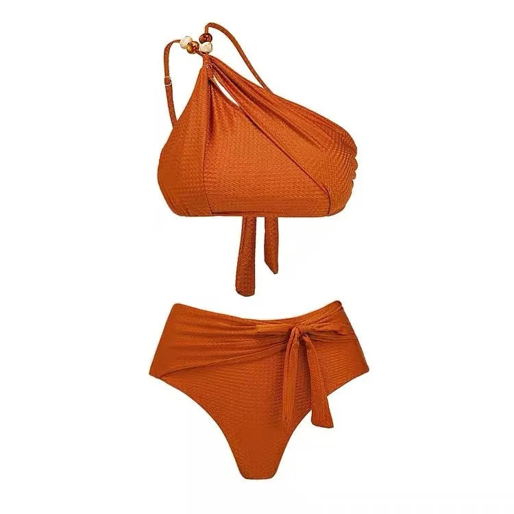 Women's brown push-up high-waist bikini with a matching chiffon skirt cover-up laid flat.